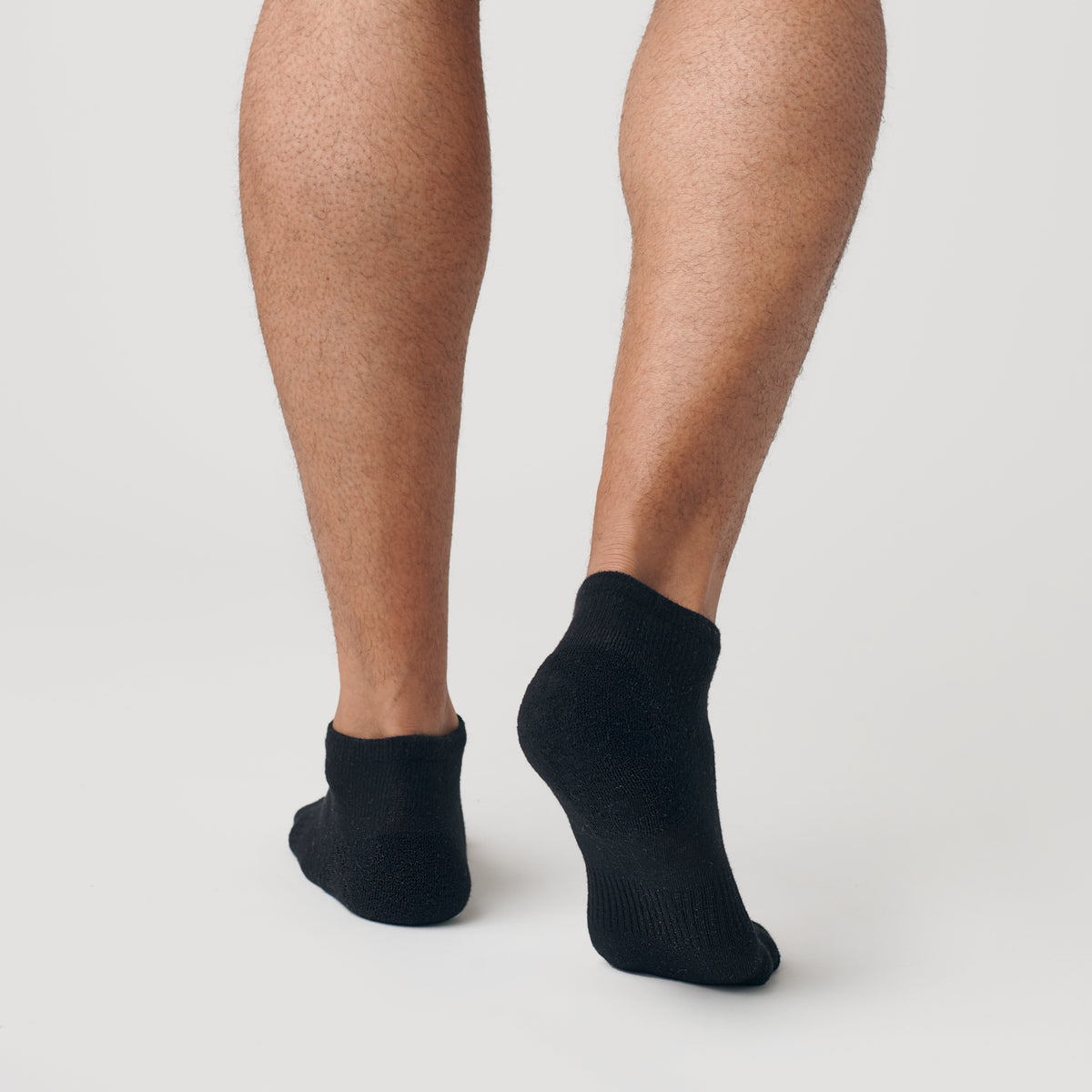 Black Ankle Socks 6-Pack shown on feet from behind.