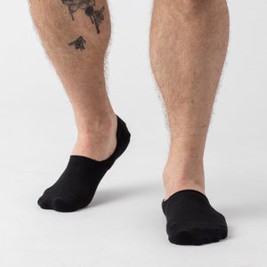True ClassicBlack Never Show Socks 12-Pack on tattooed leg with bees.