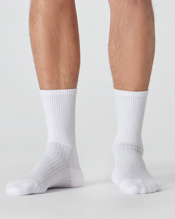 White Active Crew Socks 3-Pack on person’s legs, showcasing ribbed texture.