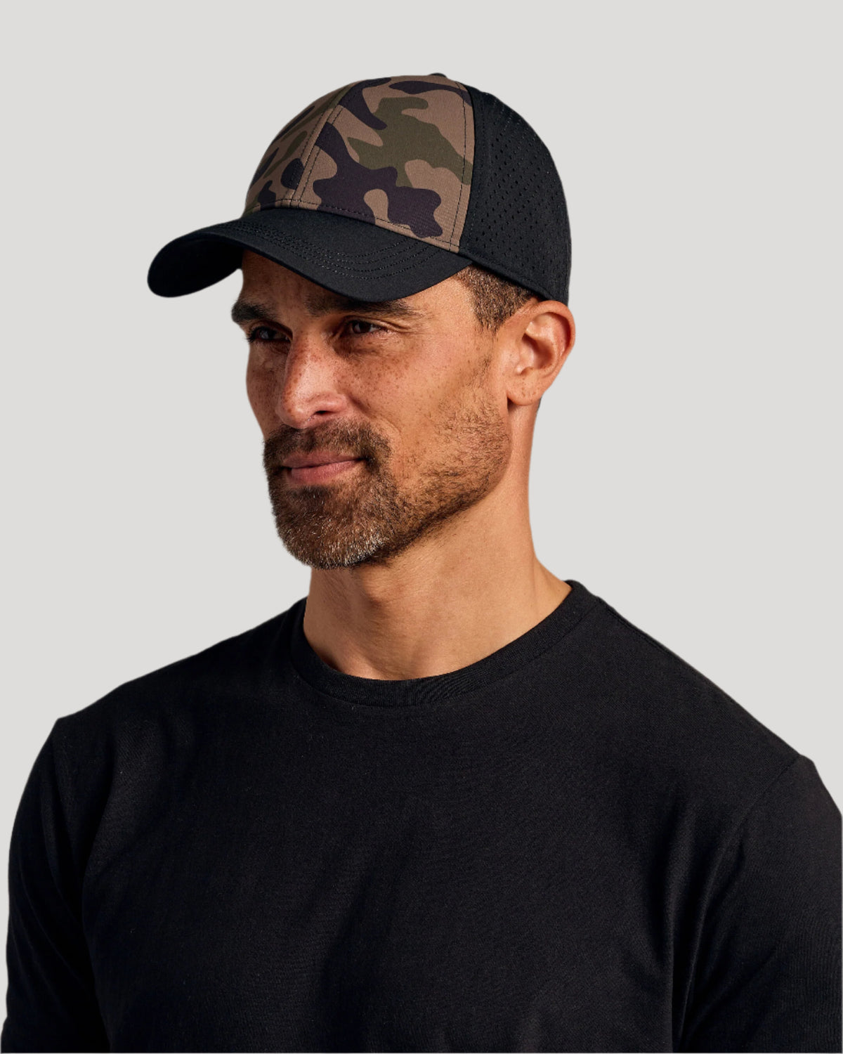 Man wearing the Olive Camo All Purpose Cap.
