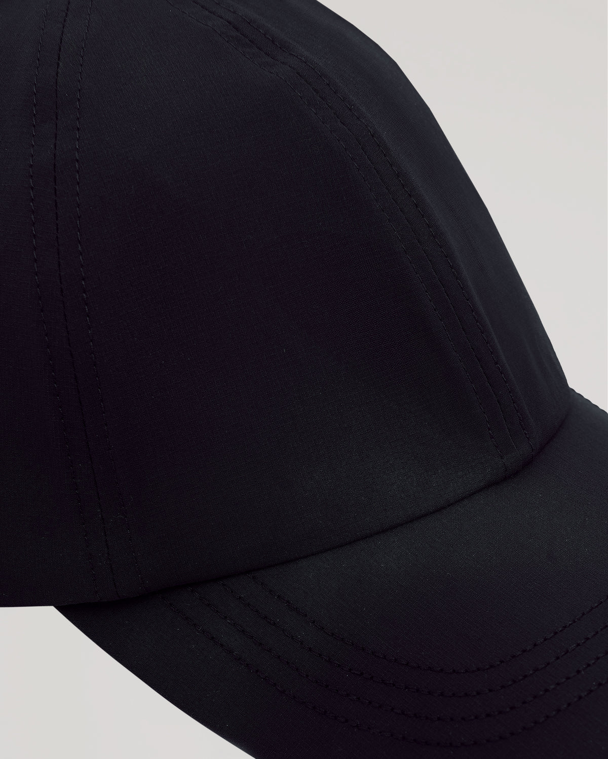 Black Active Running Cap with breathable fabric and adjustable closure.