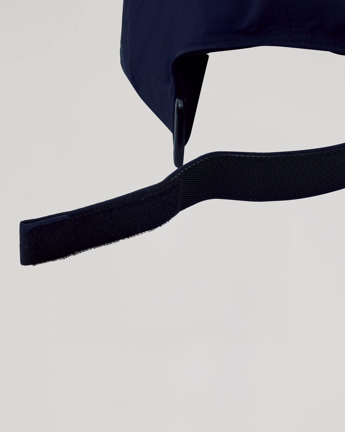 Navy Active Running Cap with unfastened Velcro adjustment strap.