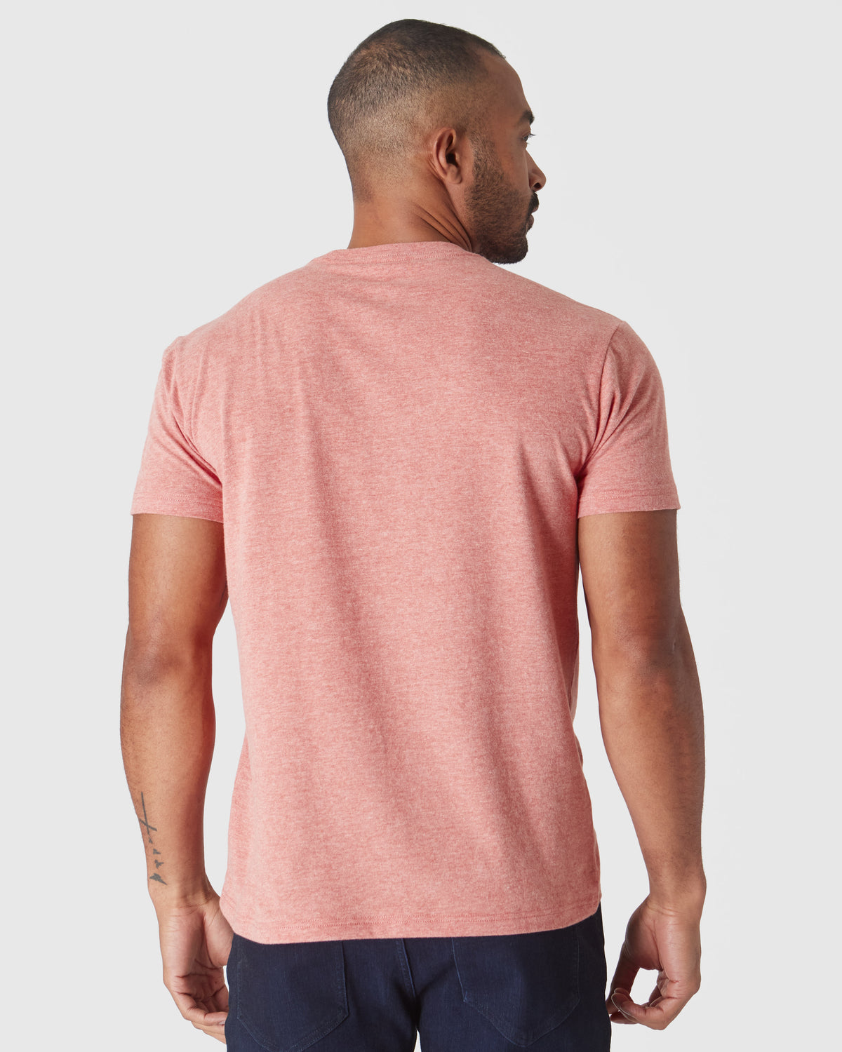 Man wearing Heather Cayenne Classic Crew Neck with visible forearm tattoo.
