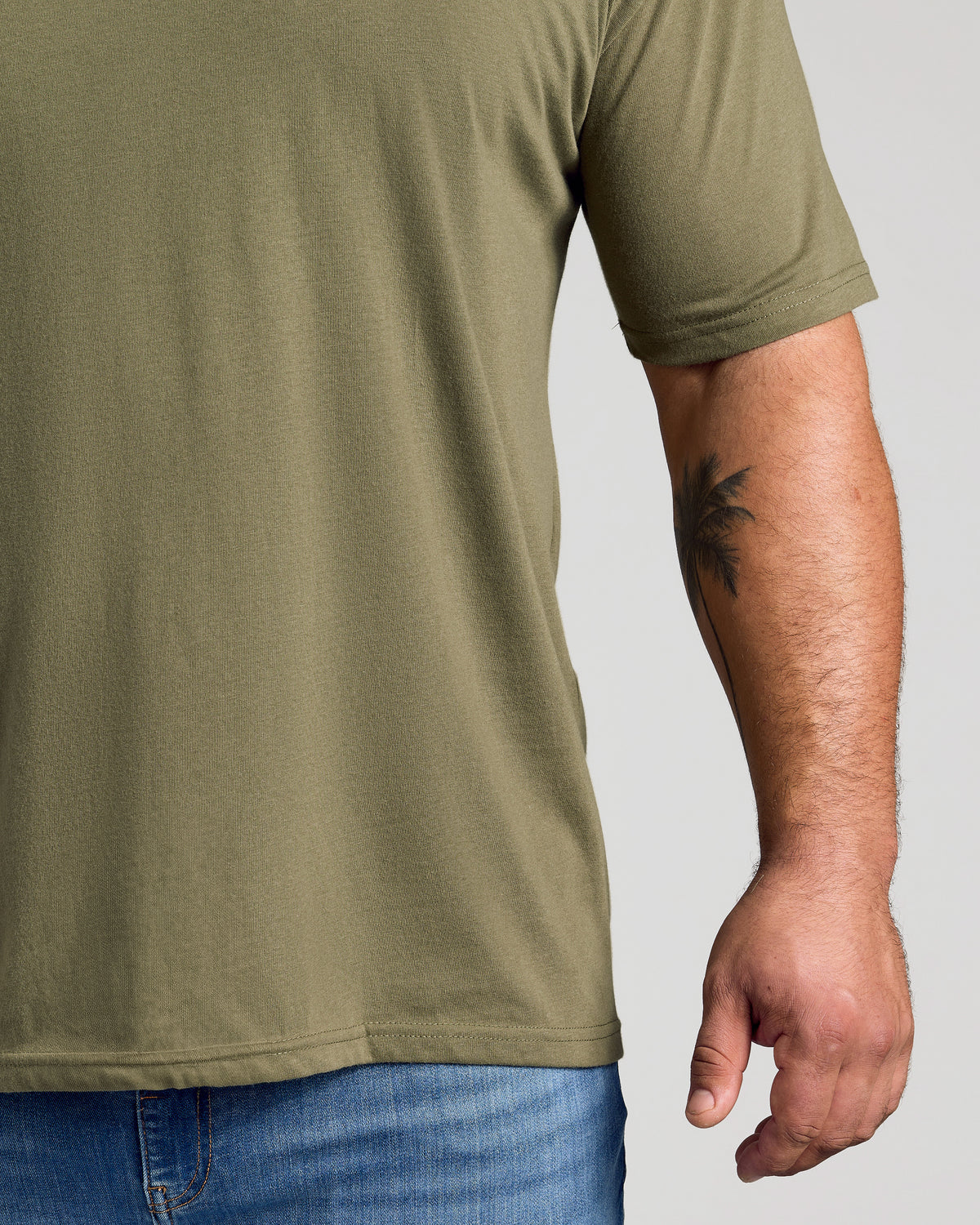 Military green crew neck t-shirt with short sleeves on model.