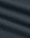 A close-up of dark navy blue fabric with a fine textured weave and soft diagonal folds.