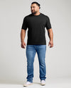 Black classic crew neck t-shirt on male model with blue jeans and white sneakers.