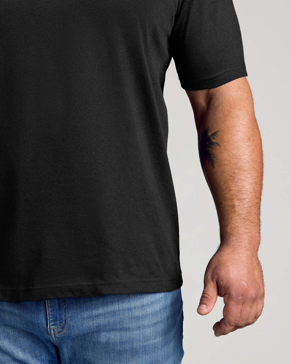 Black crew neck t-shirt with short sleeves and a relaxed fit.