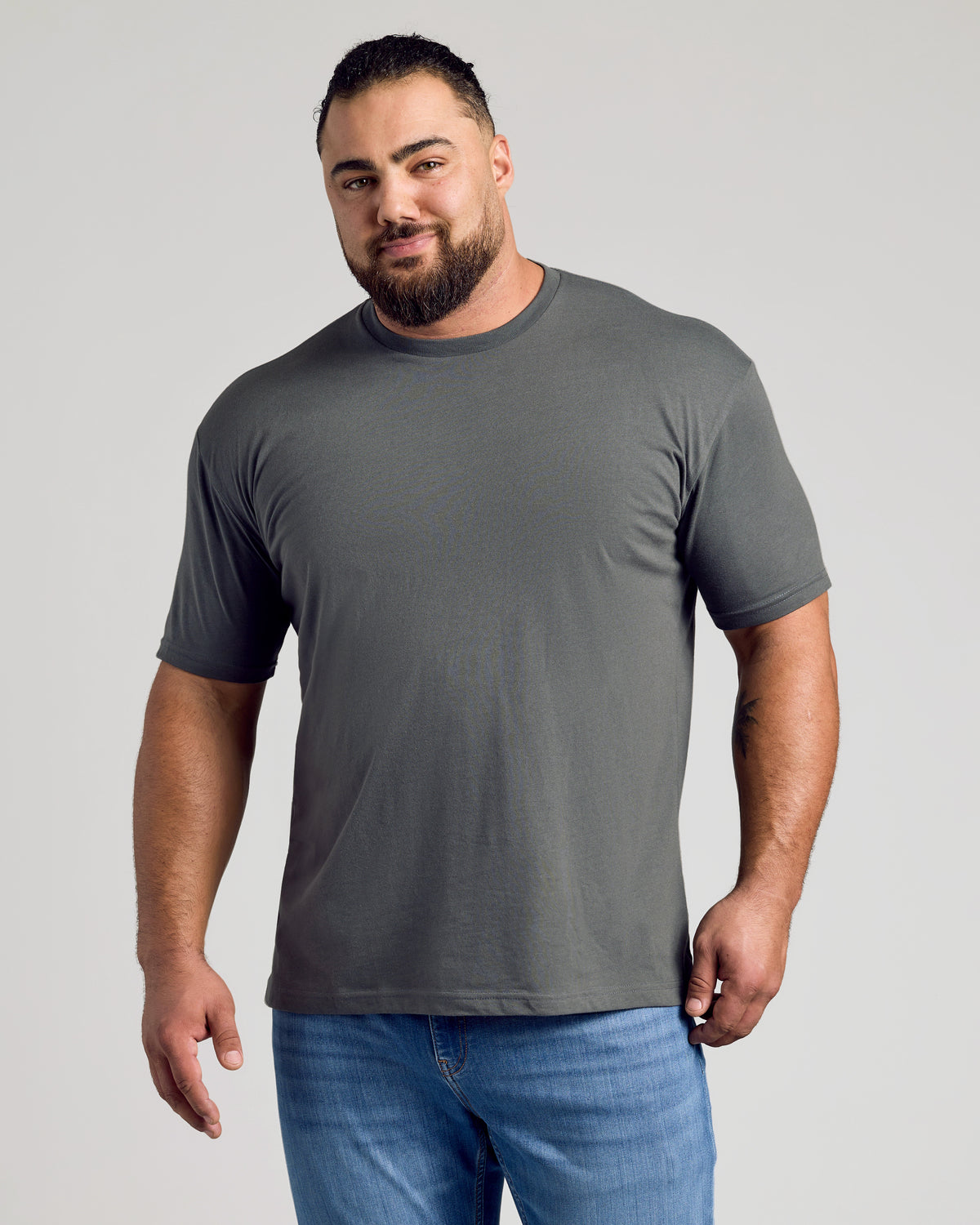 Man wearing Carbon Classic Crew Neck T-shirt, showcasing its fitted design.