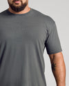 Man wearing Carbon Classic Crew Neck showcasing tattooed forearm.