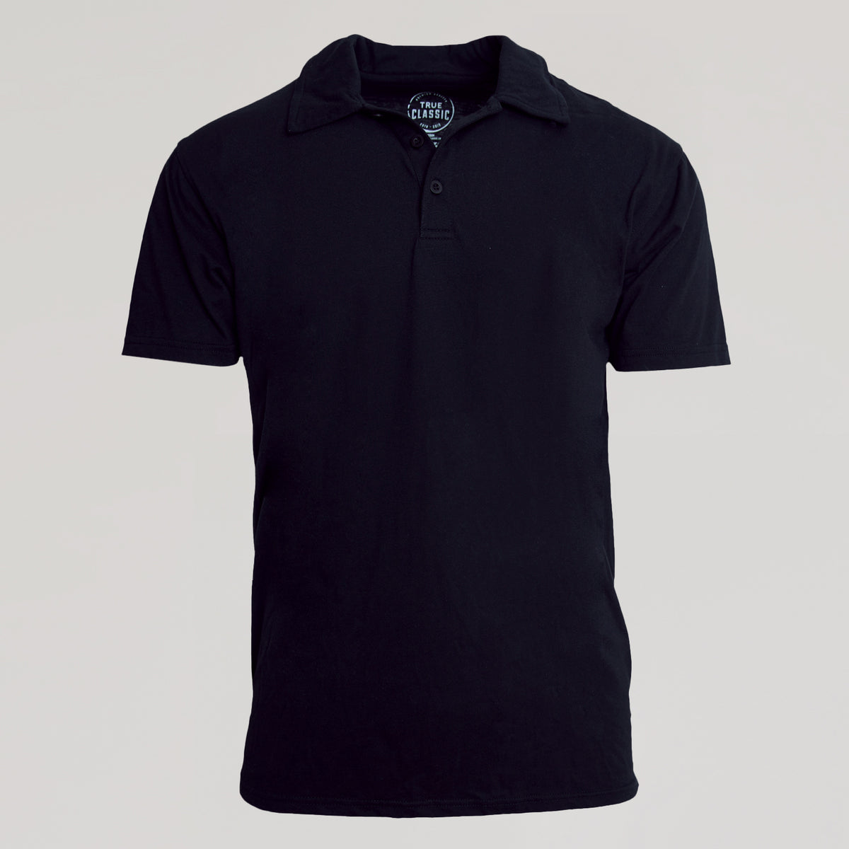 Black Classic Polo with button-up collar and “TRUE CLASSIC.” neck label.