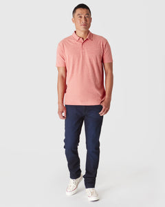 True ClassicMan wearing Heather Cayenne Classic Polo and slim-fit jeans.