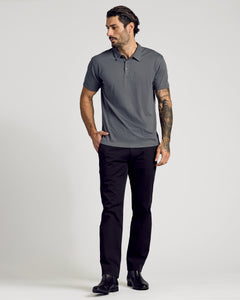 True ClassicMan wearing Carbon Classic Polo with black pants and boots.