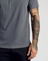 Carbon Classic Polo worn by a person with tattooed arm.