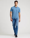 Man wearing Indigo Classic Polo with jeans and black boots.