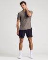 Man in Heather Cocoa Active Crew Neck Tee, black shorts, white sneakers.