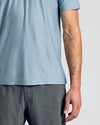 Heather Indigo Active Crew Neck Tee, showcasing tattoos on model's forearm.