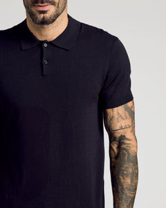 True ClassicBlack Short Sleeve Sweater Polo worn by tattooed man, showcasing slim fit.