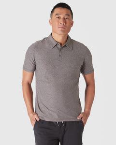 True ClassicHeather Cocoa Active Polo 2.0 worn by man against light background.