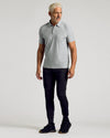 Man wearing Heather Light Gray Active Polo with black pants and shoes.