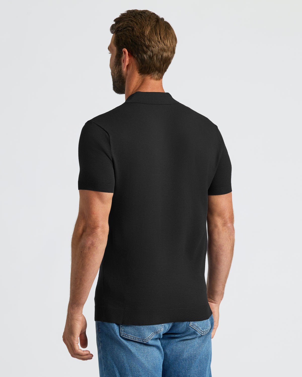 Man wearing Black Dressy Polo with ribbed hem and cuffs.