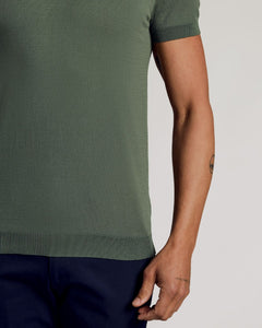 True ClassicMoss Dressy Polo on a person, showing fit and forearm tattoos.