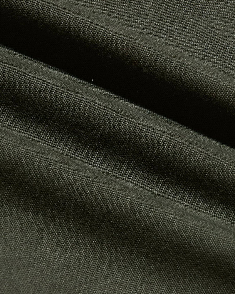 Dark green fabric with visible texture and folds