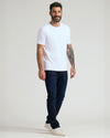 Man wearing Pima Cotton Blend Crew 4-Pack T-shirt, jeans, sneakers.