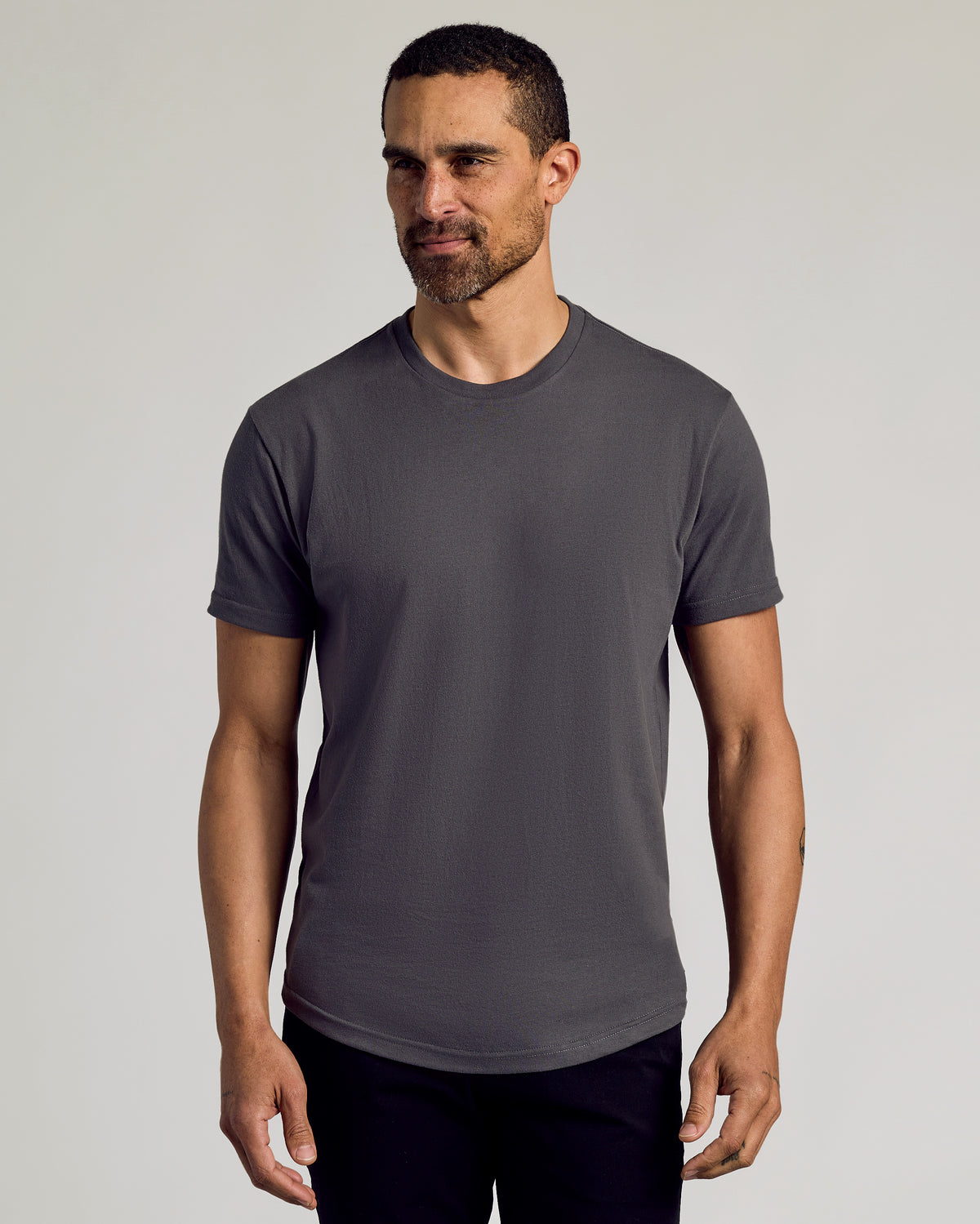 Man modeling Classic Curved Hem Crew Neck 10-Pack, wearing charcoal gray T-shirt.