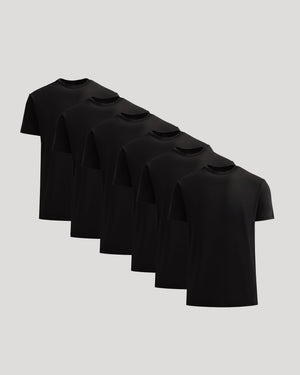 Set of six black t-shirts on a light gray background