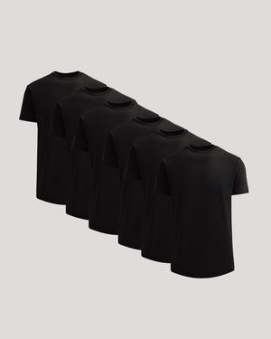 Six black crew neck t-shirts arranged in a diagonal row displaying the True Classic Men's Heavyweight Curved Hem Crew – Premium Heavyweight Cotton Blend, Modern Athletic Fit, Structured Everyday T-Shirt in men's basics style.