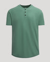 Neo Fern Heavyweight Curved Hem Henley shirt in muted green with short sleeves and a three-button placket, designed as a men's basic with a relaxed fit.