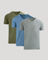 Three short-sleeve V-neck t-shirts in olive green, light blue, and heather gray, arranged in a layered overlapping display on a light gray background.