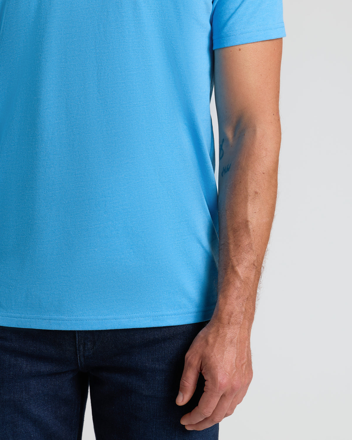 Dark Heather Bahama Blue Classic V-Neck worn with dark blue jeans.