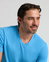 Man wearing Dark Heather Bahama Blue Classic V-Neck, showcasing fit and style.