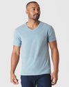 Model in Heather Sapphire Classic V-Neck and dark pants.