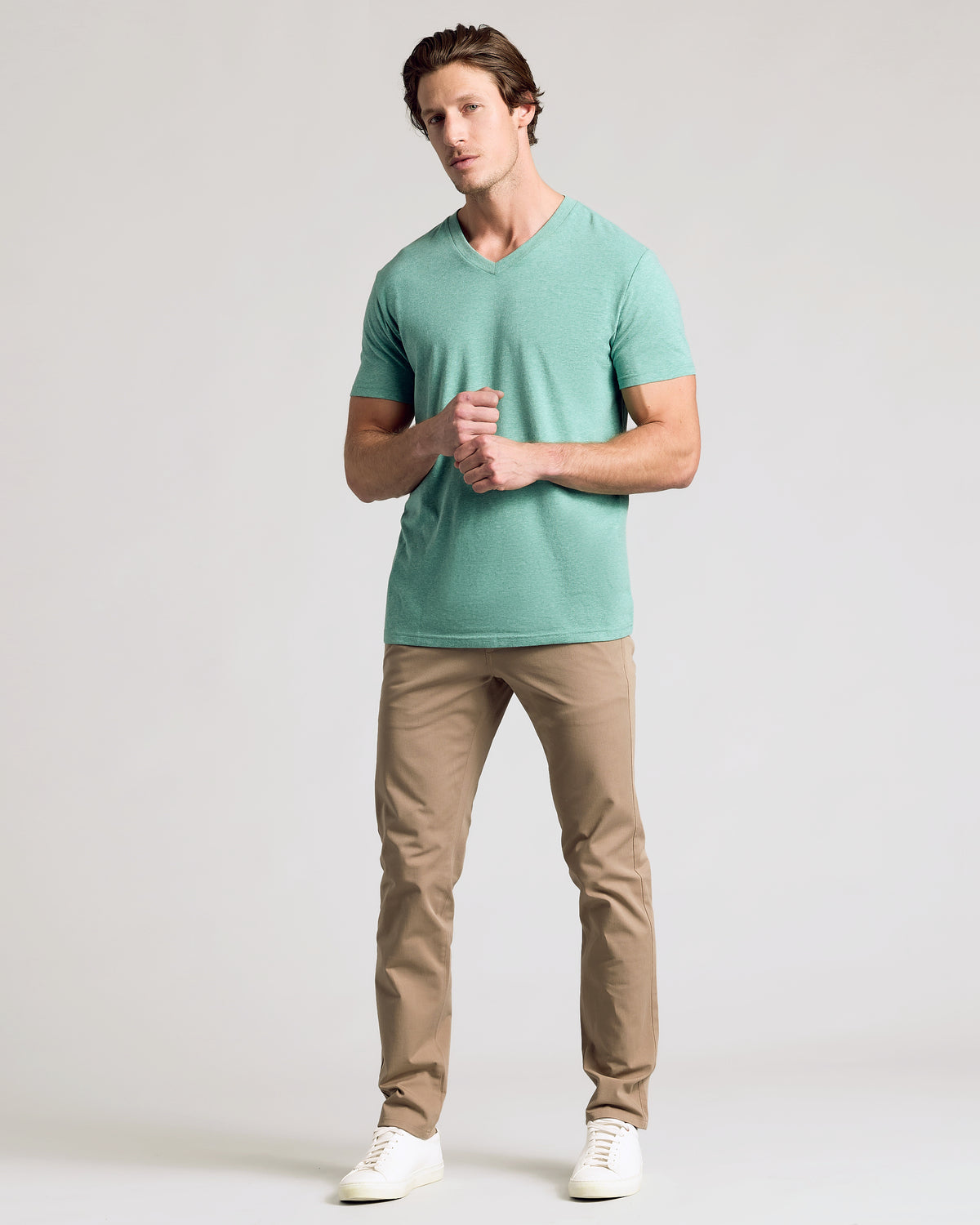Light Heather Greenery Classic V-Neck worn by man with tan trousers.