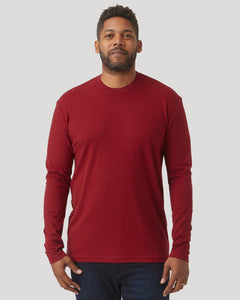 True ClassicMan wearing a crimson long sleeve crew neck shirt, posing against a plain gray background, showcasing a men's basics style.