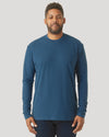 Person in Deep Sea Blue Long Sleeve T-Shirt, relaxed arms, dark pants.