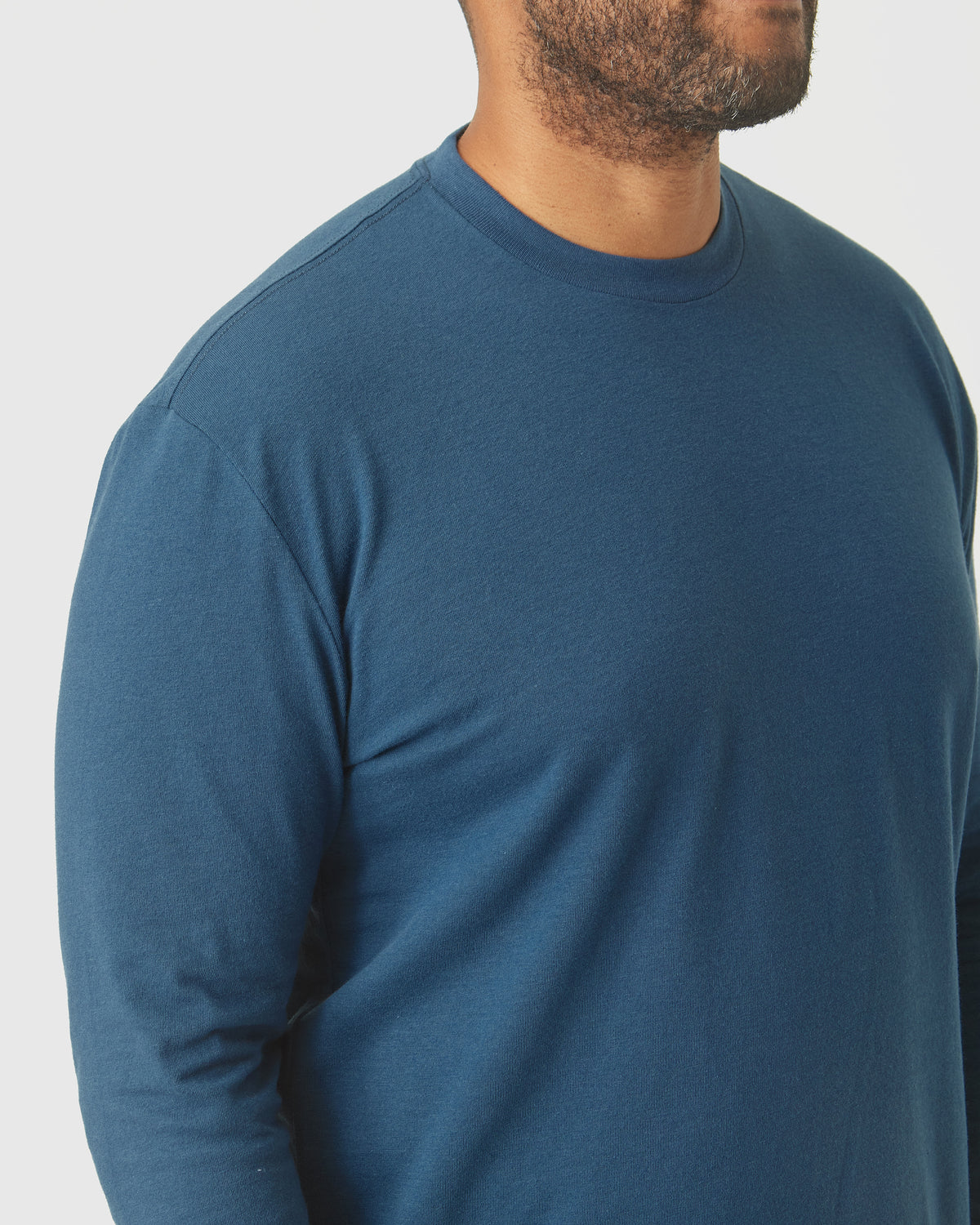 Deep Sea Blue Long Sleeve T-Shirt on model's upper torso.