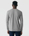 Person wearing Glacier Gray Long Sleeve Henley, paired with dark blue jeans.