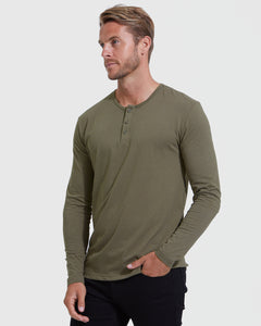 True ClassicMan in Military Green Classic Long Sleeve Henley and dark pants.