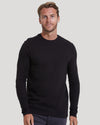 Man wearing a fitted Black Waffle Long Sleeve Crew Neck shirt with a textured waffle knit pattern, styled as a men's basic layering piece.