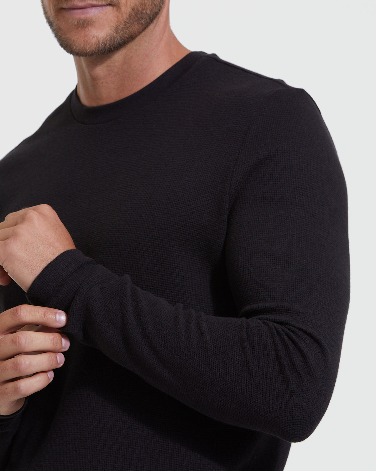 Close-up of a man wearing a Black Waffle Long Sleeve Crew Neck, featuring a textured waffle knit fabric and a comfortable fit, ideal for men's basics.