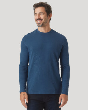 Man wearing Deep Sea Blue Long Sleeve Waffle Crew, smiling.