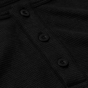 True ClassicClose-up of the black textured waffle fabric and black buttons on the Black Waffle Long Sleeve Henley 3-Pack, showing details of men's basics style.