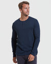 Man in Navy Waffle Long Sleeve Henley with dark trousers.