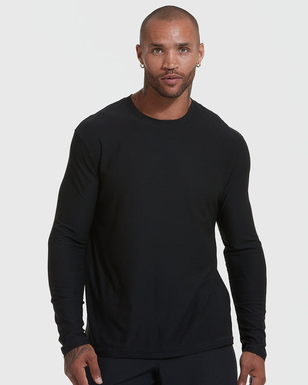 Man wearing Standard Active Long Sleeve Crew T-Shirt in black.