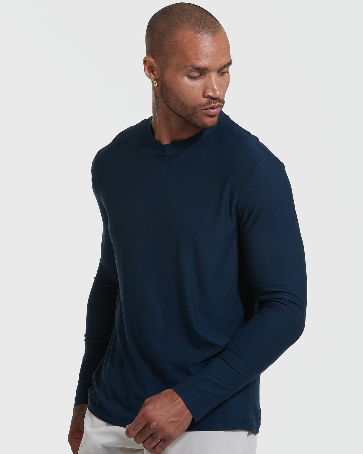 Man in Navy Active Long Sleeve Crew T-Shirt against gray background.