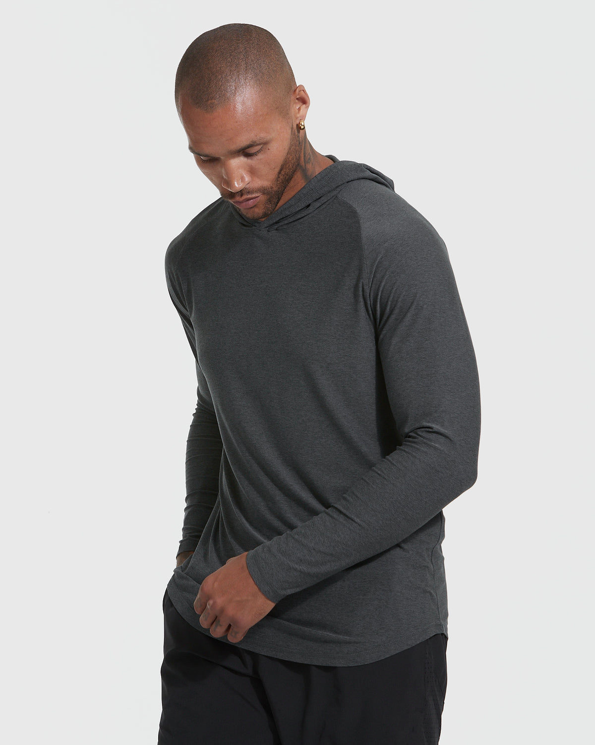 Man in Charcoal Heather Gray Active Hoodie, hands in pocket, casual look.
