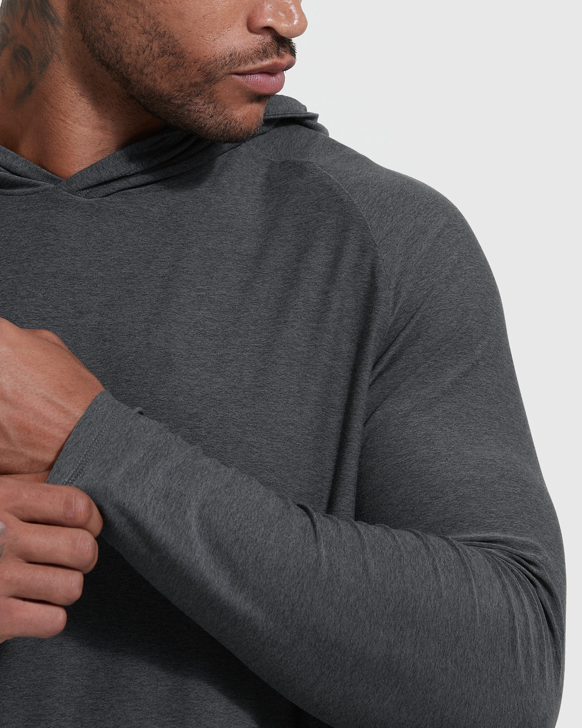 Man adjusting sleeve of Charcoal Heather Gray Active Hoodie.